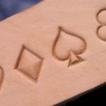 Card symbols imprints on vag tanned cow hide Leather