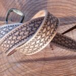 Leather belt decorated with toolpaw stamps